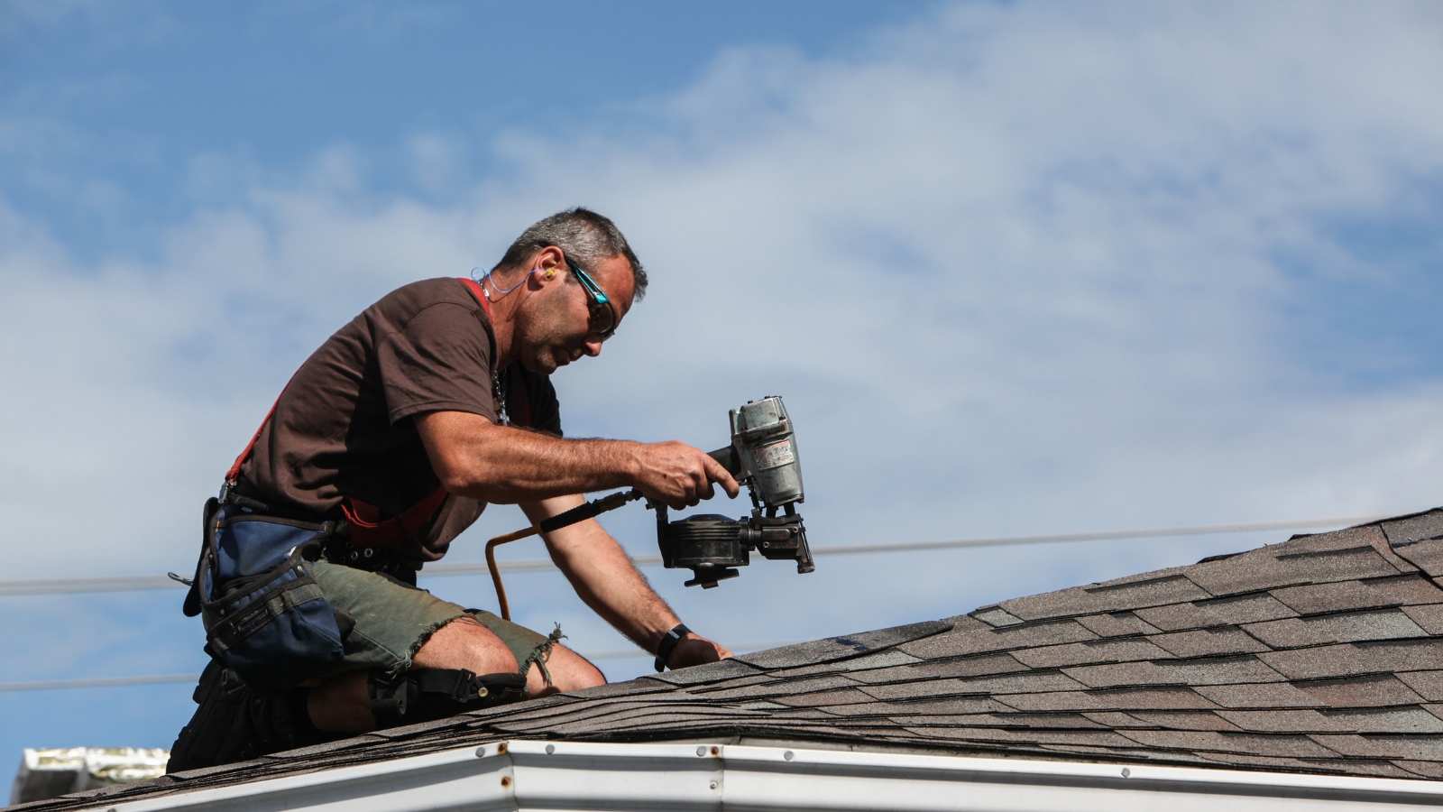 A man installing shingles.